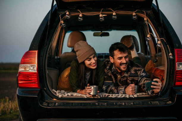 istock Happy couple having a conversation while lying in their van 2152450499