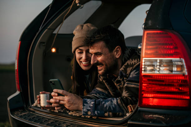 istock Happy couple having a conversation while lying in their van 2152450501