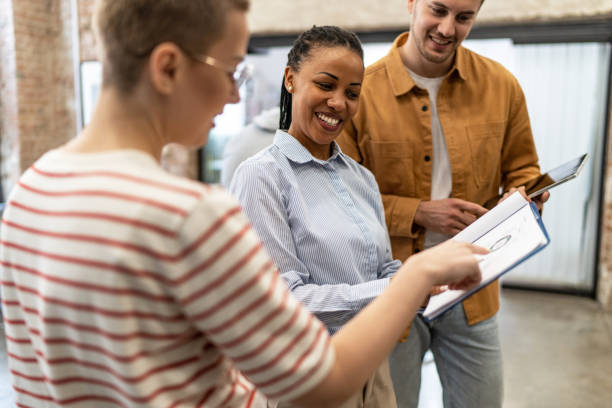 istock Young diverse colleagues having a casual business discussion 2152450562