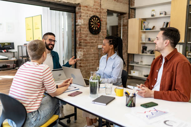 istock Diverse group of co-workers having casual discussion in office 2152452038