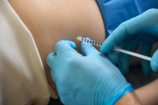 istock Doctor anesthetizing area of client skin before dermatologic surgery 2152452828