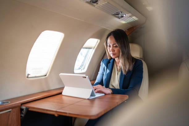 istock Asian Businesswoman Engaged in Work on Private Jet 2152453263