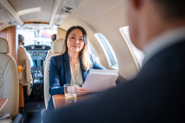 istock Mature Asian Executives Conduct Business in Private Jet 2152453267