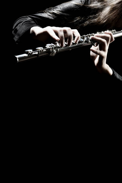 istock Flute instrument. Flutist hands playing flute music 2152454206