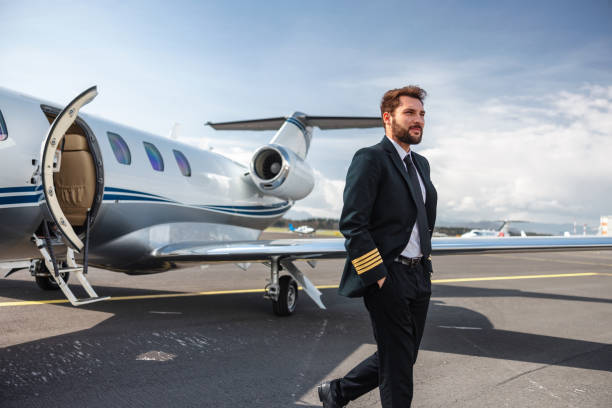 istock Confident Pilot Walking by a Private Jet on Runway 2152454847