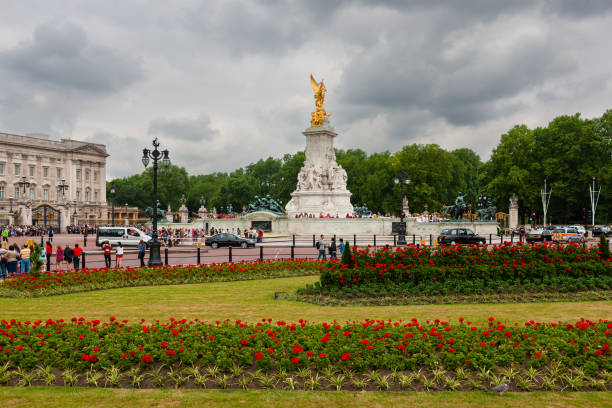 London, United Kingdom - June 30, 2010 : Crowds waiting for a Royal appearance around a monument to Queen Victoria.