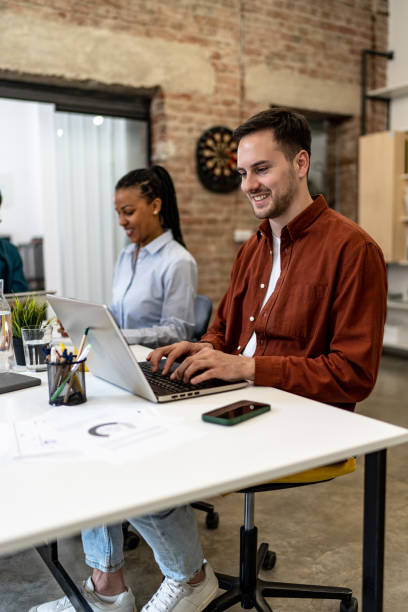 istock Young businessman working on laptop at the modern office 2152455421
