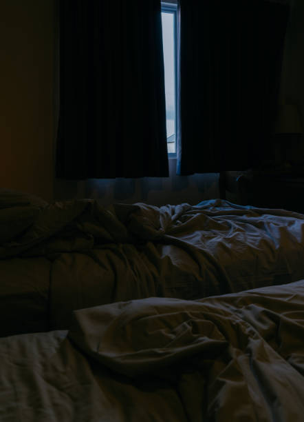 istock Dark bedroom with light from the window. 2152456196