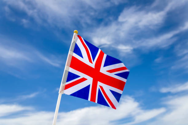 istock Union Jack in front of the sky and clouds 2152460967