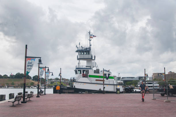 Baltimore, Maryland. September 30, 2019. The historic Cape May tugboat docked within the inner harbor located in Baltimore Maryland on an overcast day.