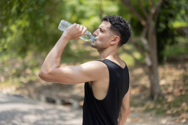 istock A man drink water from bottle in a park 2152471052
