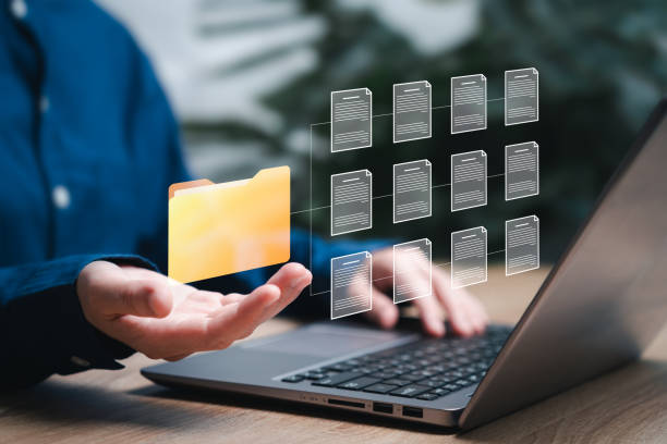 istock DMS Document management and archiving storage system Concept, Businesswomen hold digital folders and documents online and Use laptops to search document files data, Software for efficient archiving 2152471270