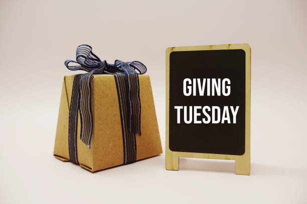 istock Giving Tuesday text message write on blackboard and gift box on pink background 2152481923