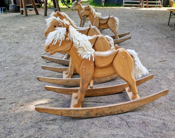 Three-year-old hispanic boy having fun on a vintage rocking horse.