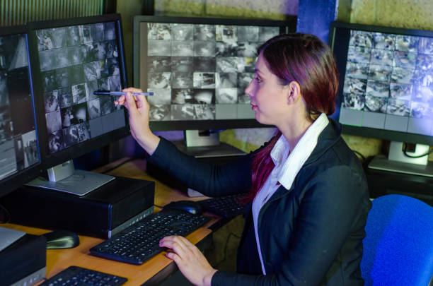 istock Young woman working on surveillance control room looking the monitors at the security office 2152483973
