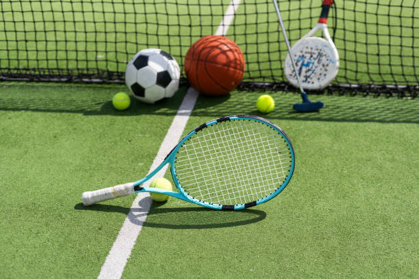 istock Different sport equipment on green grass, flat lay. Space for text 2152486586