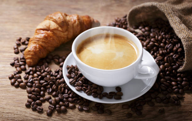 istock Cup of coffee, croissant and coffee beans 2152488358