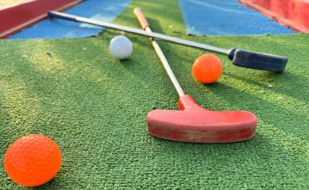 istock colorful golf putters with golf balls on synthetic grass 2152488884