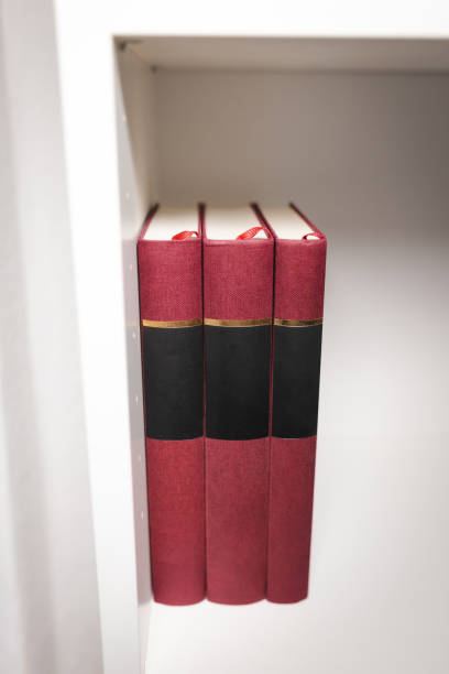 Close-up of a stack of books on a white bookshelf.