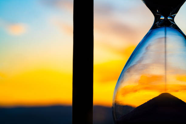 istock Hourglass and city at sunset 2152490550
