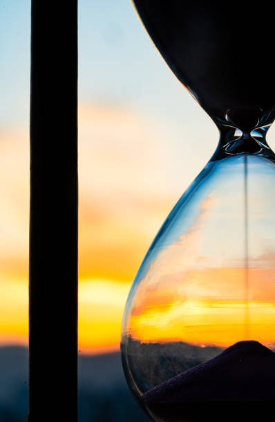 istock Hourglass and city at sunset 2152490553