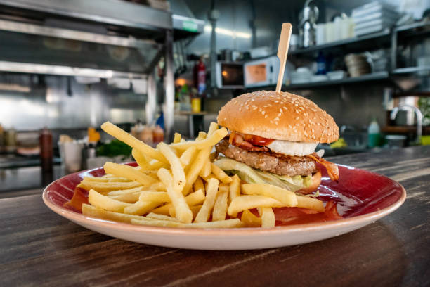 istock Beef burger with bacon and eggs with fries 2152500426
