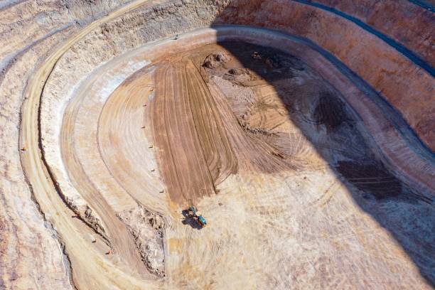 istock Open pit mine in full operation, with machinery extracting minerals. 2152501270