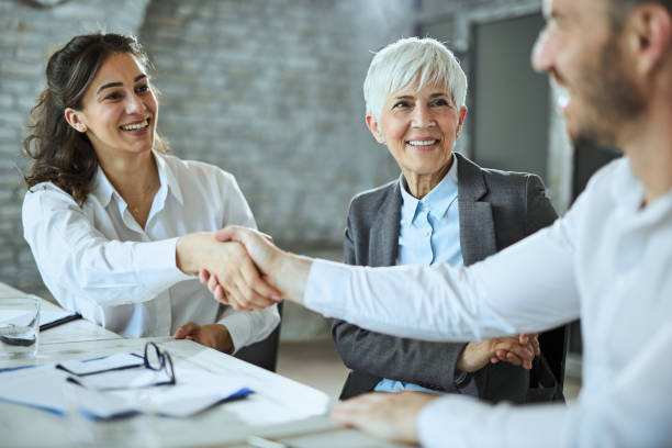 istock Happy  entrepreneurs shaking hands during a meeting in the office 2152503365