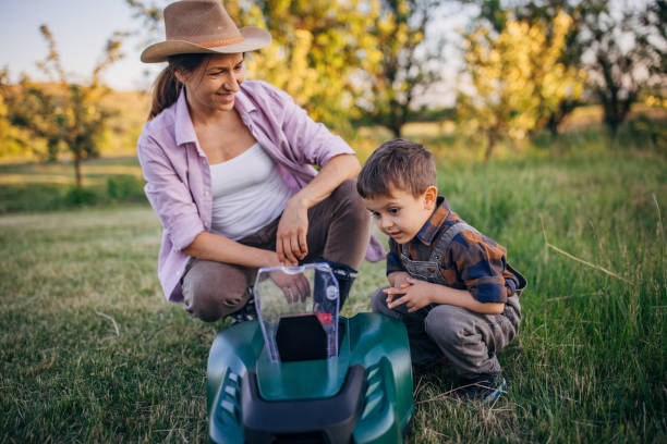 istock Family bonding time with robot mower on farm 2152505257