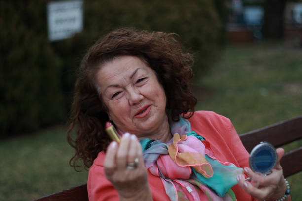 modern senior woman in public park makeup