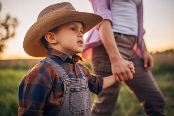 istock Woman farmer enjoys a beautiful sunset with her son 2152507855