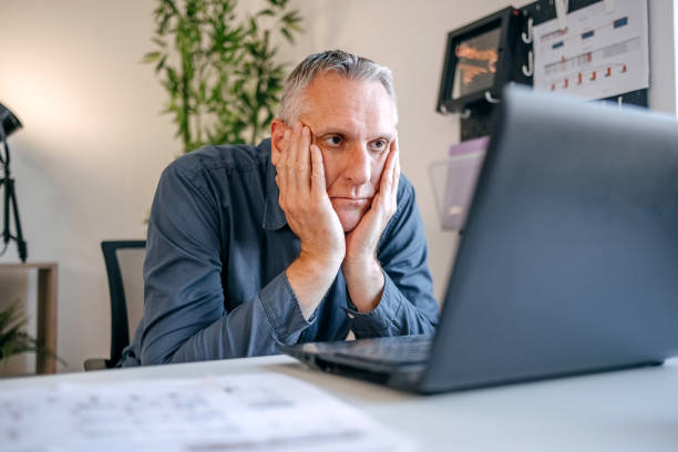istock Man working overtime using laptop and analysing results 2152508183