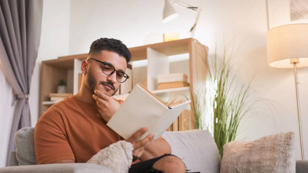 istock Reading leisure home rest curious man with book 2152517847
