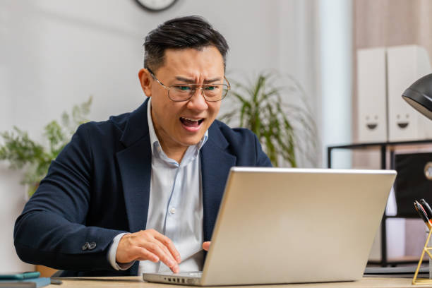 istock Irritated tired businessman working on laptop website problem, computer virus data loss by hacking 2152519132