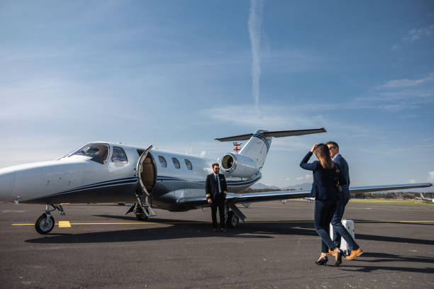 istock Business Executives Walking Toward Private Jet for Travel 2152523803