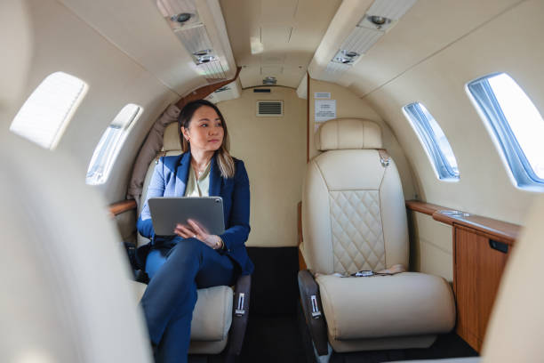 istock Professional Woman Using Digital Tablet in Private Jet 2152523876