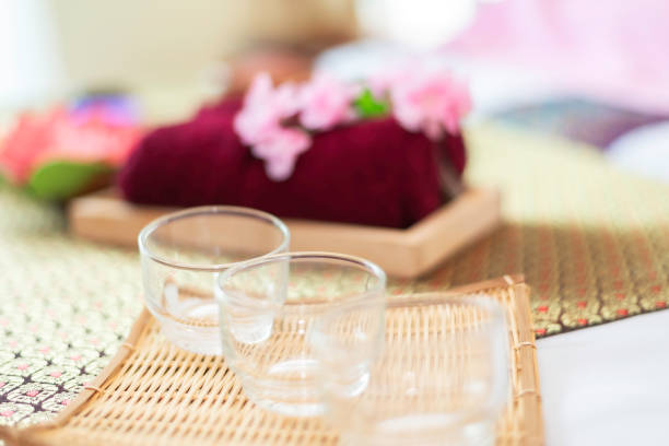 spa massage wellness decorations setting on wood table. thai spa massage traditional compress for hot massage and spa relaxing treatment of office syndrome. massage for health concept.