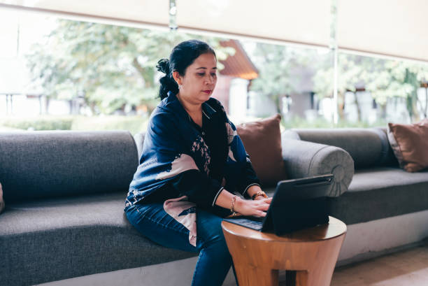 istock asian senior  woman  using tablet when Working from Anywhere in flexible working 2152533469