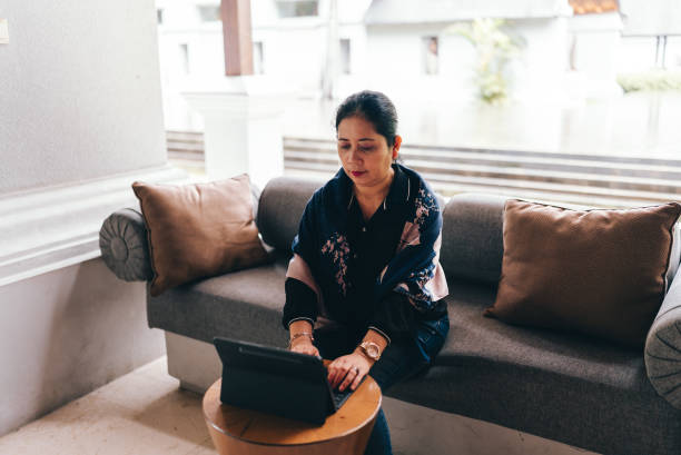 istock asian senior  woman  using tablet when Working from Anywhere in flexible working 2152533473