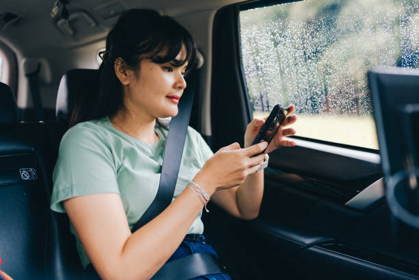asian woman  using phone in the car