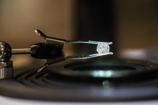 A naked diamond is observed under a magnifying glass.