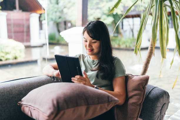 istock asian woman  using tablet when Working from Anywhere in flexible working 2152535651