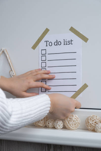 istock Unrecognizable woman creating vision board with Motivational paper note TO DO LIST. Goals setting concept. Strategy for self development improvement. Inspirational Planning better healthier life 2152537145