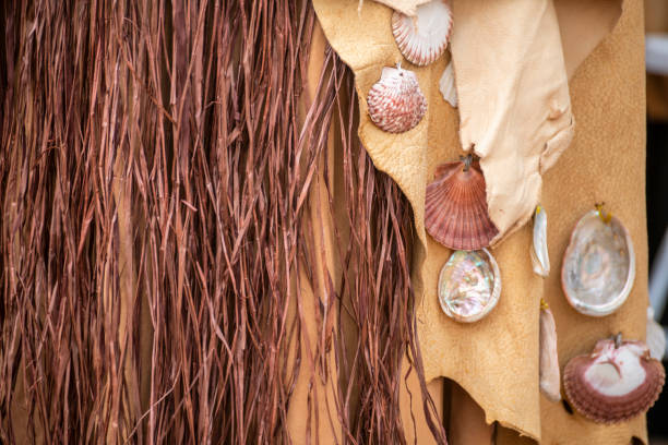Native American dress decorated with sea shells creating an intricate design showcases creativity and skill of the designer.