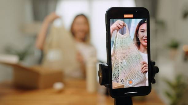 istock Asian woman  influencer unboxing open cardbox order gift parcel reusable bottles in zero waste recycling,sustainable lifestyle,plastic free envionment ,eco friendly concept ,live streaming record online video in living room at home 2152541354