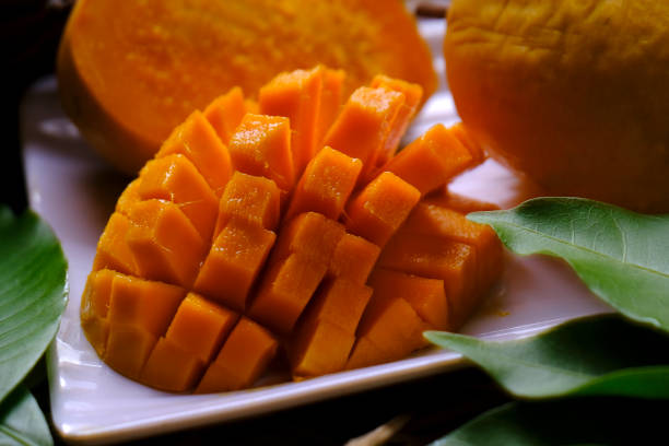 istock Mango tropical fruit with green leaf, Ripe mango in grass closeup 2152543759