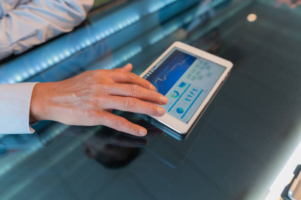 Close-up Hand Businessman viewing business chart and analyzing market data