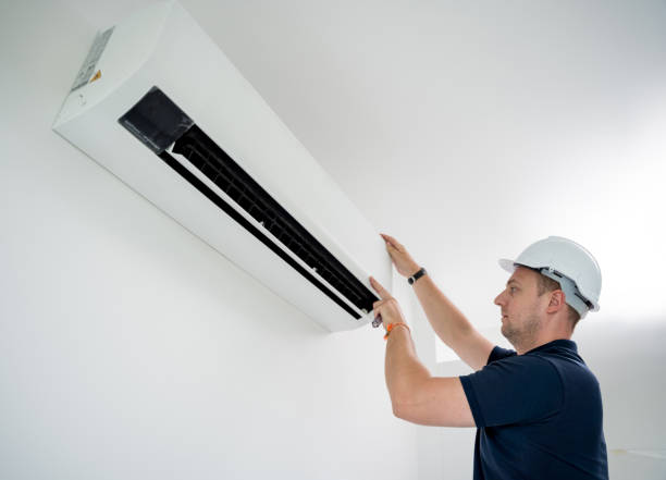 istock technician cleans air conditioner system in a modern apartment. 2152549599