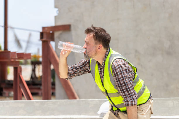 istock Worker man in hardhat drinking water at container cargo, Engineer man drinking water at the precast factory site 2152550675