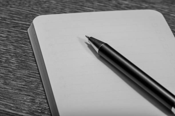 istock A pen lies on an empty, written open notebook with white sheets of paper 2152550779